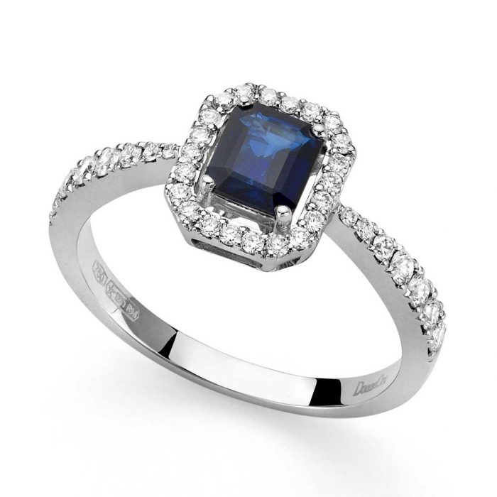 18-karat white gold ring with diamonds and sapphire in the middle
